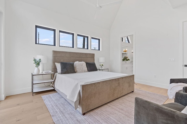 814 Stark St, Austin, TX 78756 - bedroom featuring high vaulted ceiling, light wood-style floors, baseboards, and ensuite bathroom