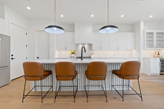814 Stark St, Austin, TX 78756 - kitchen with freestanding refrigerator, premium range hood, decorative backsplash, light countertops, and recessed lighting