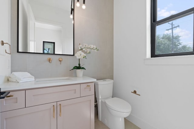 814 Stark St, Austin, TX 78756 - bathroom featuring vanity, toilet, tile patterned flooring, and tasteful backsplash