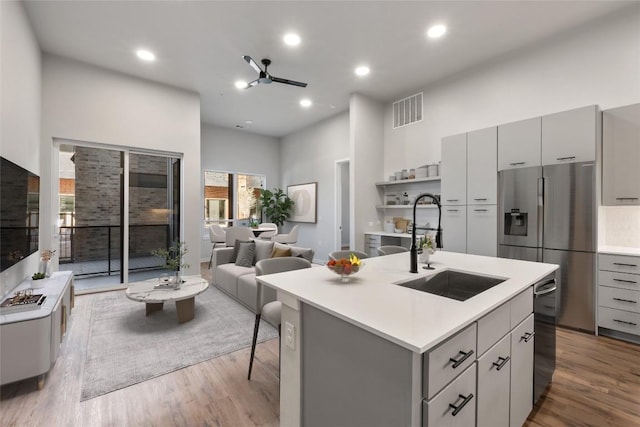 4510 Terry-O Ln Unit 141, Austin, TX 78745 - kitchen featuring gray cabinets, appliances with stainless steel finishes, light countertops, a high ceiling, and wood finished floors