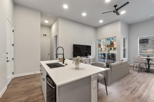 4510 Terry-O Ln Unit 141, Austin, TX 78745 - kitchen with dishwasher, open floor plan, wood finished floors, an island with sink, and light countertops
