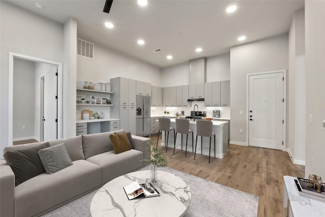 4510 Terry-O Ln Unit 141, Austin, TX 78745 - living room with a high ceiling, light wood finished floors, and recessed lighting