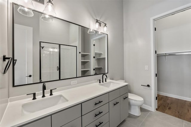 4510 Terry-O Ln Unit 141, Austin, TX 78745 - bathroom with a spacious closet, double vanity, a shower stall, and tile patterned floors
