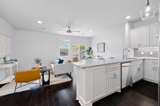 5901 Bolm Rd Unit H, Austin, TX 78721 - kitchen featuring dishwasher, a sink, a peninsula, dark wood-type flooring, and recessed lighting