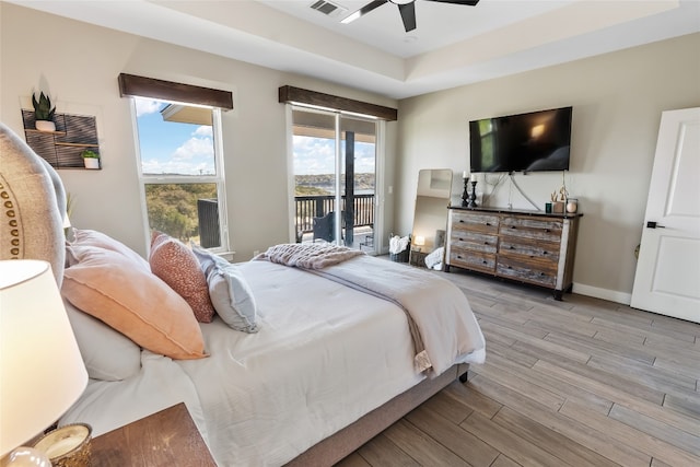 bedroom with access to outside, ceiling fan, baseboards, wood finished floors, and visible vents