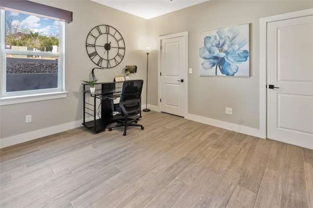 home office with light wood-style floors and baseboards