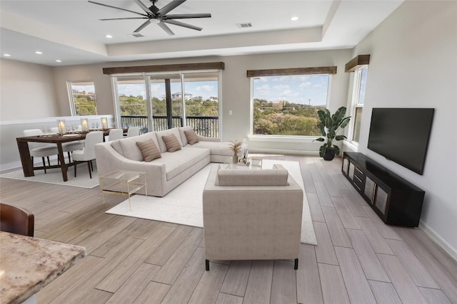 315 Southwind Rd, Point Venture, TX 78645 - living room featuring light wood-style flooring, ceiling fan, a raised ceiling, and recessed lighting