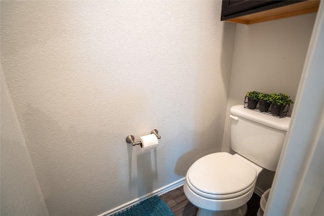 168 Onna St, Taylor, TX 76574 - bathroom with toilet and wood finished floors