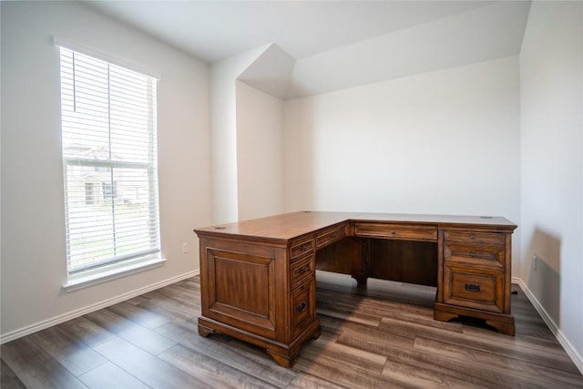 unfurnished office featuring dark wood-type flooring and baseboards