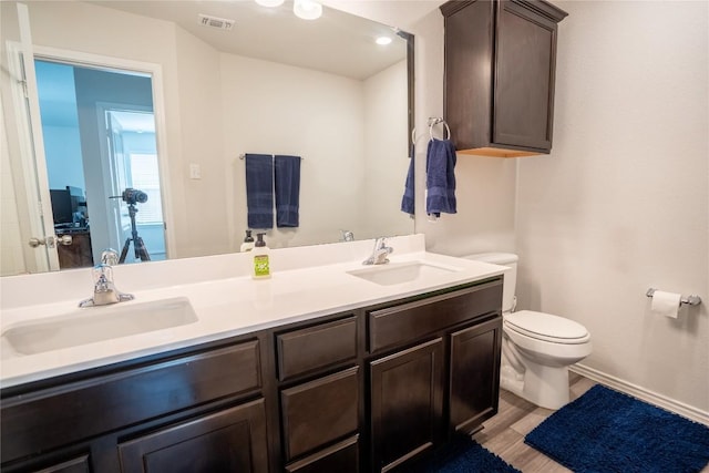 168 Onna St, Taylor, TX 76574 - bathroom with double vanity and wood finished floors