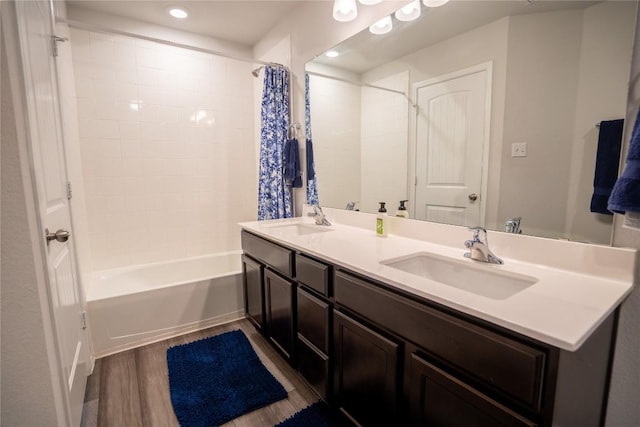 168 Onna St, Taylor, TX 76574 - full bathroom with double vanity, shower / bathtub combination with curtain, wood finished floors, and recessed lighting