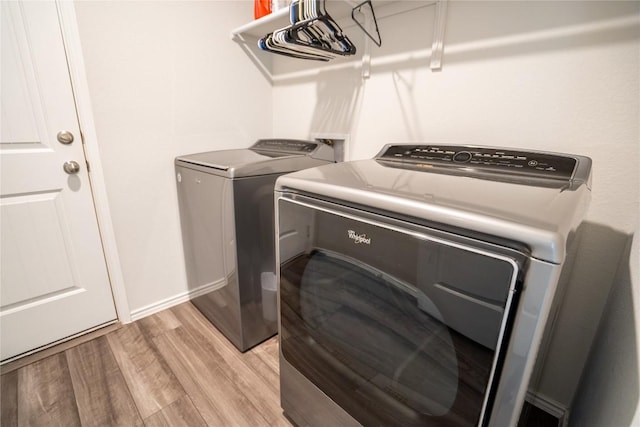 168 Onna St, Taylor, TX 76574 - laundry area featuring light wood finished floors and washer and dryer