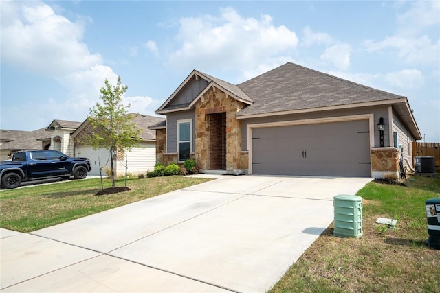 168 Onna St, Taylor, TX 76574 - view of front of property featuring stone siding, a garage, concrete driveway, a front yard, and roof with shingles