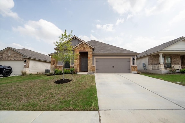 168 Onna St, Taylor, TX 76574 - craftsman-style house featuring an attached garage, a front yard, concrete driveway, and stone siding
