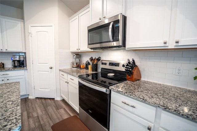 168 Onna St, Taylor, TX 76574 - kitchen with appliances with stainless steel finishes, backsplash, dark wood-type flooring, white cabinetry, and light stone countertops
