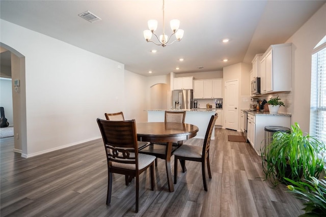 168 Onna St, Taylor, TX 76574 - dining room with arched walkways, dark wood finished floors, a chandelier, and recessed lighting