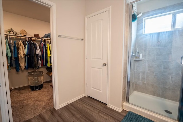 168 Onna St, Taylor, TX 76574 - full bathroom with a shower stall, wood finished floors, and a spacious closet