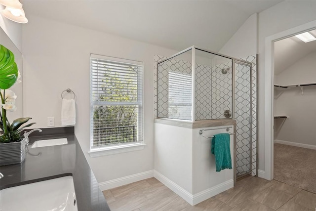306 Gulfton St, Austin, TX 78738 - full bath with a shower stall, a spacious closet, baseboards, lofted ceiling, and double vanity