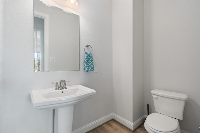 306 Gulfton St, Austin, TX 78738 - half bath with toilet, wood finished floors, and baseboards
