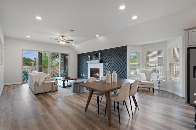 306 Gulfton St, Austin, TX 78738 - dining area featuring a brick fireplace, baseboards, ceiling fan, wood finished floors, and recessed lighting