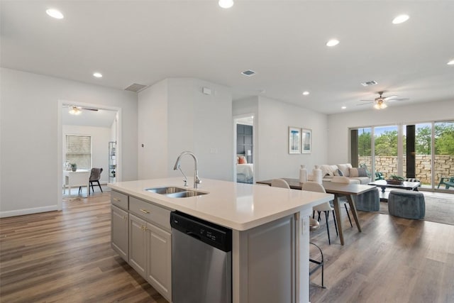 306 Gulfton St, Austin, TX 78738 - kitchen with stainless steel dishwasher, a ceiling fan, a center island with sink, light countertops, and open floor plan