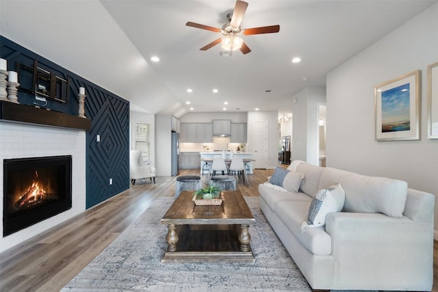 306 Gulfton St, Austin, TX 78738 - living room with a ceiling fan, light wood-style floors, a brick fireplace, lofted ceiling, and recessed lighting