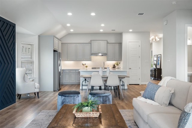 306 Gulfton St, Austin, TX 78738 - living area with a chandelier, recessed lighting, light wood finished floors, and lofted ceiling