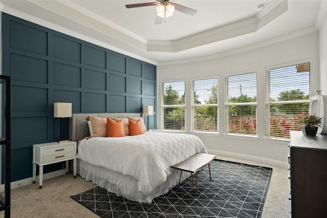 306 Gulfton St, Austin, TX 78738 - carpeted bedroom with a raised ceiling, a decorative wall, multiple windows, crown molding, and a ceiling fan
