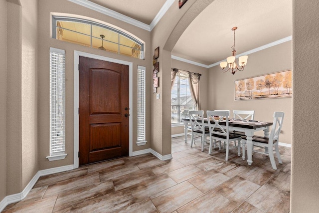11066 La Paloma Loop, Salado, TX 76571 - foyer with arched walkways, crown molding, a chandelier, and baseboards