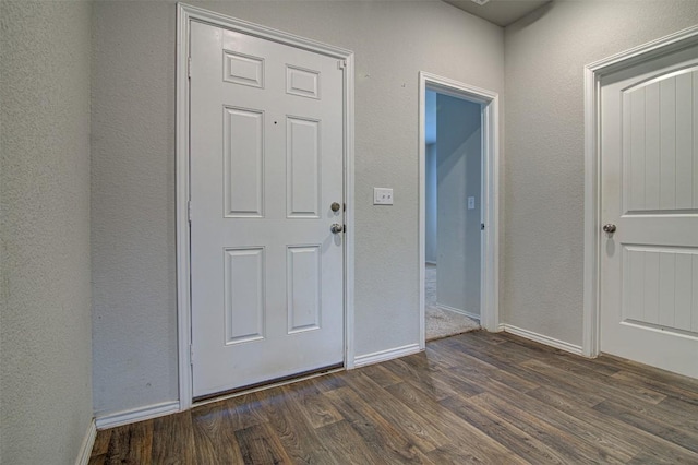 5912 Berriweather Dr, Austin, TX 78724 - foyer entrance with dark wood-type flooring, baseboards, and a textured wall