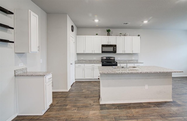5912 Berriweather Dr, Austin, TX 78724 - kitchen featuring black microwave, electric range oven, a sink, white cabinetry, and baseboards