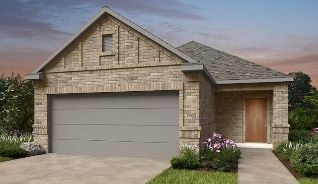737 Drystone Trl, Liberty Hill, TX 78642 - french country style house featuring an attached garage, roof with shingles, concrete driveway, and brick siding