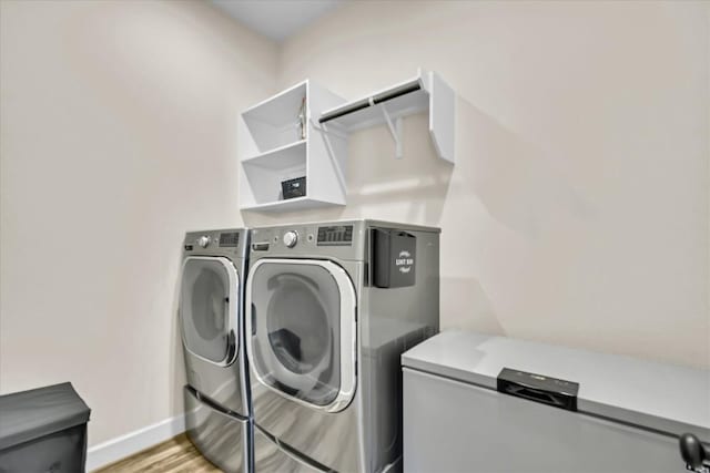 6101 Fadden Rd, Austin, TX 78738 - washroom with washer and dryer, baseboards, and light wood-type flooring