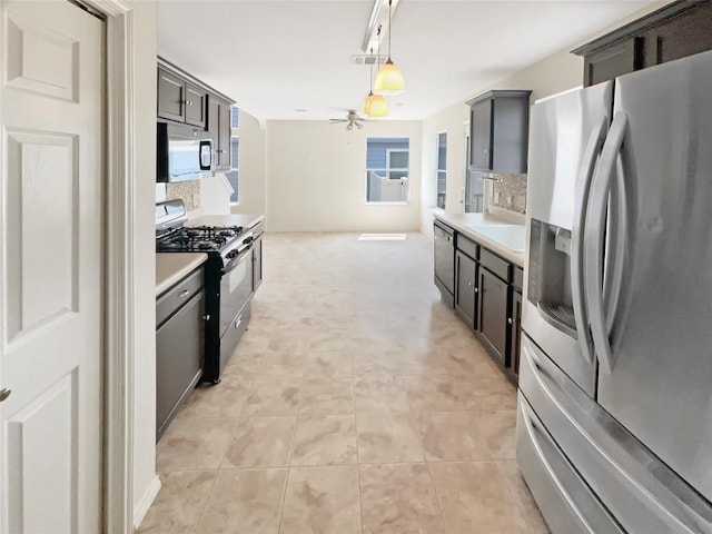 1427 Davis Mountain Loop, Cedar Park, TX 78613 - kitchen with stainless steel appliances, a ceiling fan, light countertops, and pendant lighting
