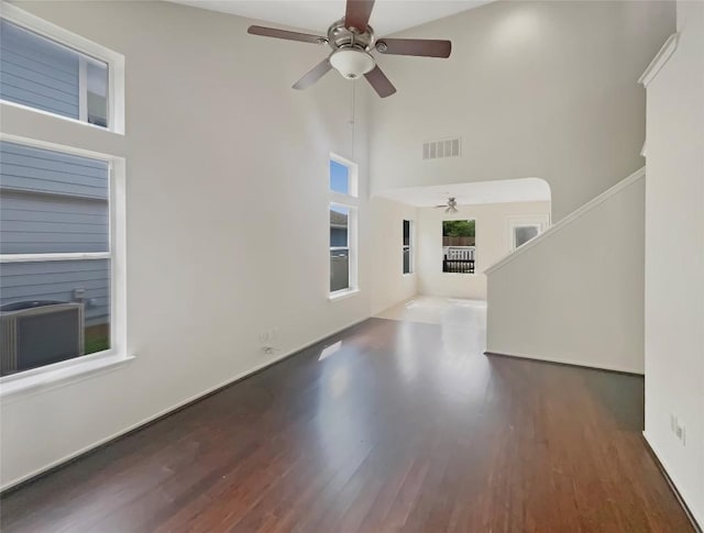 1427 Davis Mountain Loop, Cedar Park, TX 78613 - unfurnished living room with ceiling fan, wood finished floors, a high ceiling, and stairway
