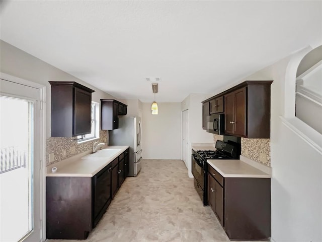 1427 Davis Mountain Loop, Cedar Park, TX 78613 - kitchen with black appliances, dark brown cabinetry, decorative backsplash, and light countertops