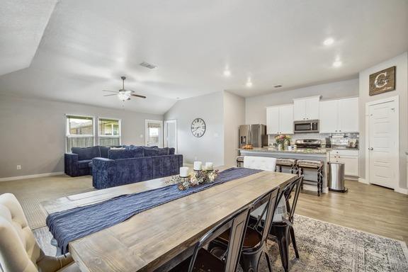 5907 Akin Run, San Antonio, TX 78261 - dining room featuring ceiling fan, vaulted ceiling, baseboards, light wood-type flooring, and recessed lighting