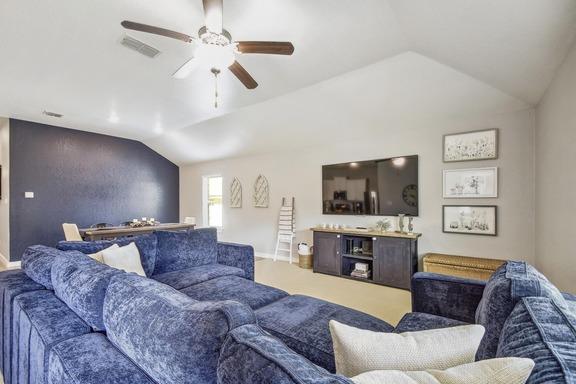 5907 Akin Run, San Antonio, TX 78261 - carpeted living room with lofted ceiling, ceiling fan, and baseboards