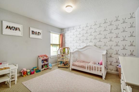 5907 Akin Run, San Antonio, TX 78261 - carpeted bedroom featuring a nursery area, baseboards, and a textured ceiling