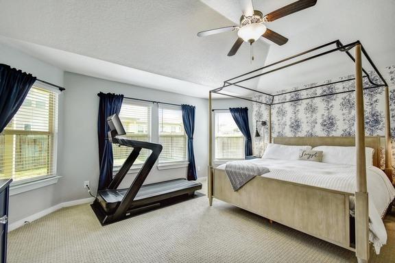 5907 Akin Run, San Antonio, TX 78261 - carpeted bedroom featuring baseboards, ceiling fan, and a textured ceiling