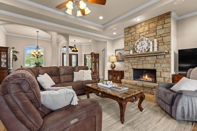 201 Aldea St, Georgetown, TX 78633 - living area featuring arched walkways, a chandelier, ceiling fan, crown molding, and a fireplace