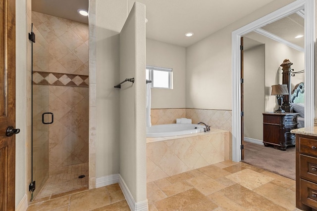 201 Aldea St, Georgetown, TX 78633 - bathroom featuring vanity, a bath, a stall shower, recessed lighting, and baseboards
