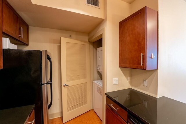 3016 Guadalupe St Unit 212, Austin, TX 78705 - kitchen with freestanding refrigerator, dark countertops, and light wood-type flooring
