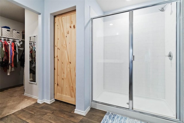 215 Whipporwill Ln, San Marcos, TX 78666 - bathroom featuring a stall shower, wood finished floors, and a spacious closet