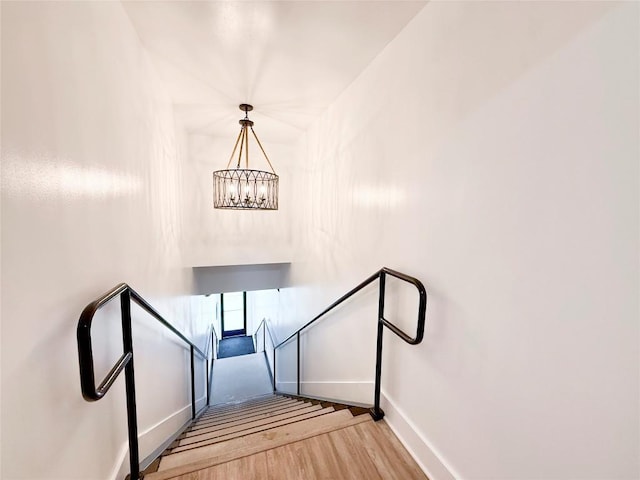 617 Main St, Lexington, TX 78947 - stairs with wood finished floors and a chandelier