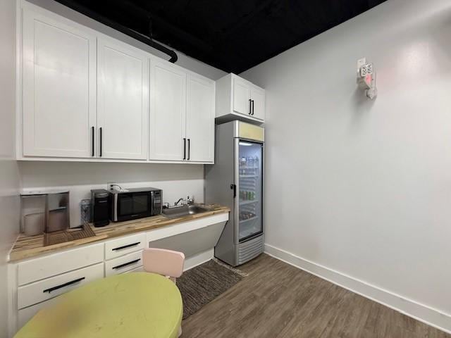 617 Main St, Lexington, TX 78947 - office area with wood finished floors and baseboards