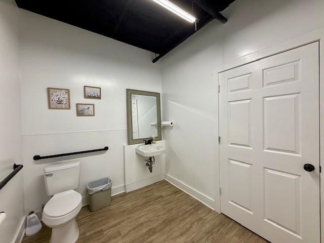 617 Main St, Lexington, TX 78947 - bathroom featuring toilet and wood finished floors