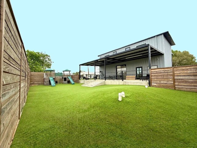 617 Main St, Lexington, TX 78947 - rear view of house featuring board and batten siding, an exterior structure, and an outdoor structure
