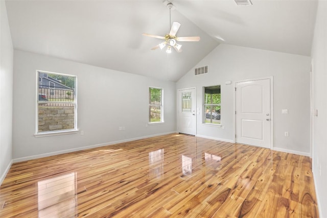 unfurnished room featuring light wood finished floors, visible vents, and a wealth of natural light
