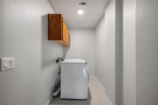 laundry area featuring washer / dryer, visible vents, light tile patterned floors, and cabinet space